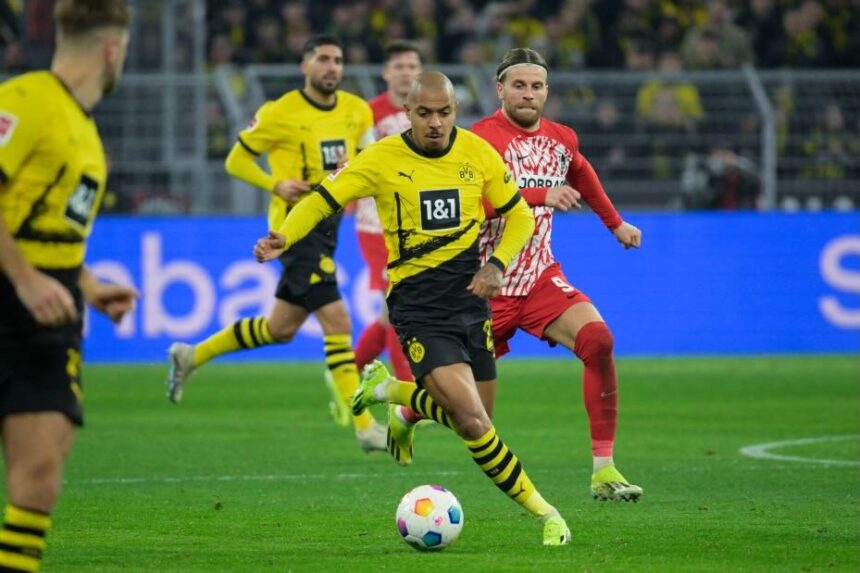 Malen double fires Dortmund past Freiburg